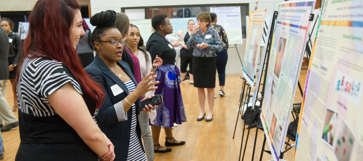 Individuals looking at research posters